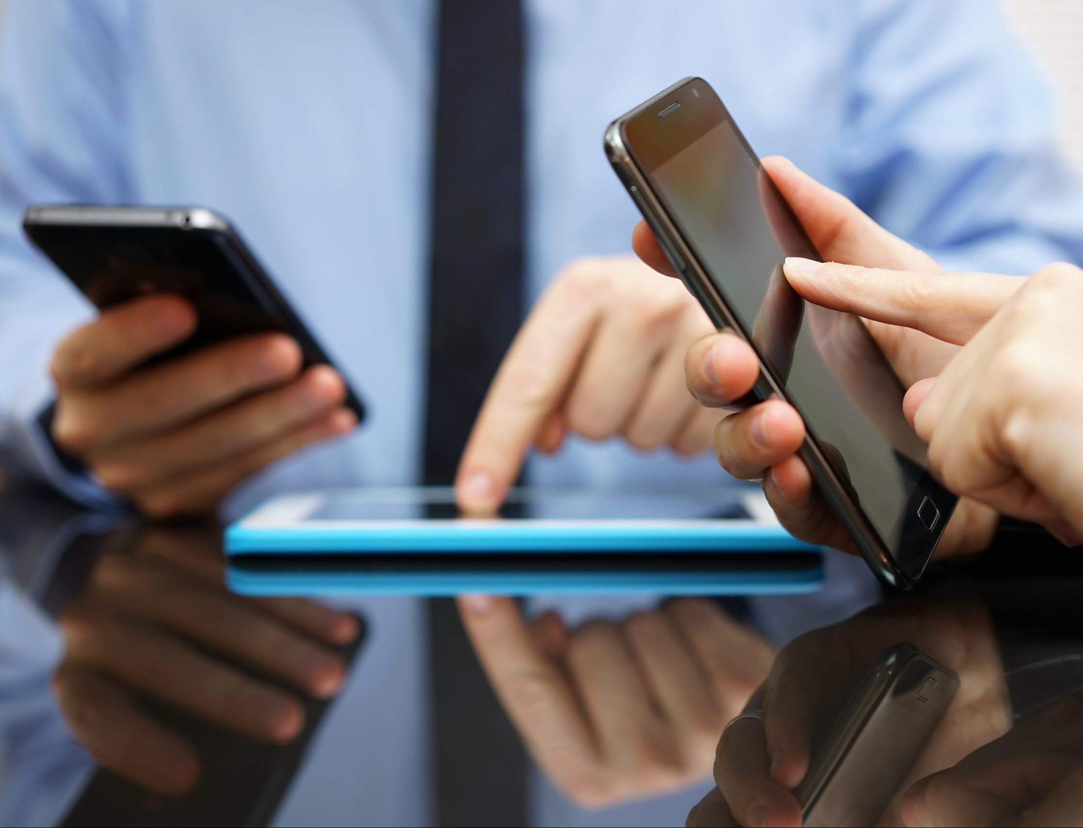 Businessman,And,Businesswoman,Working,And,Using,Smart,Mobile,Phones,And
