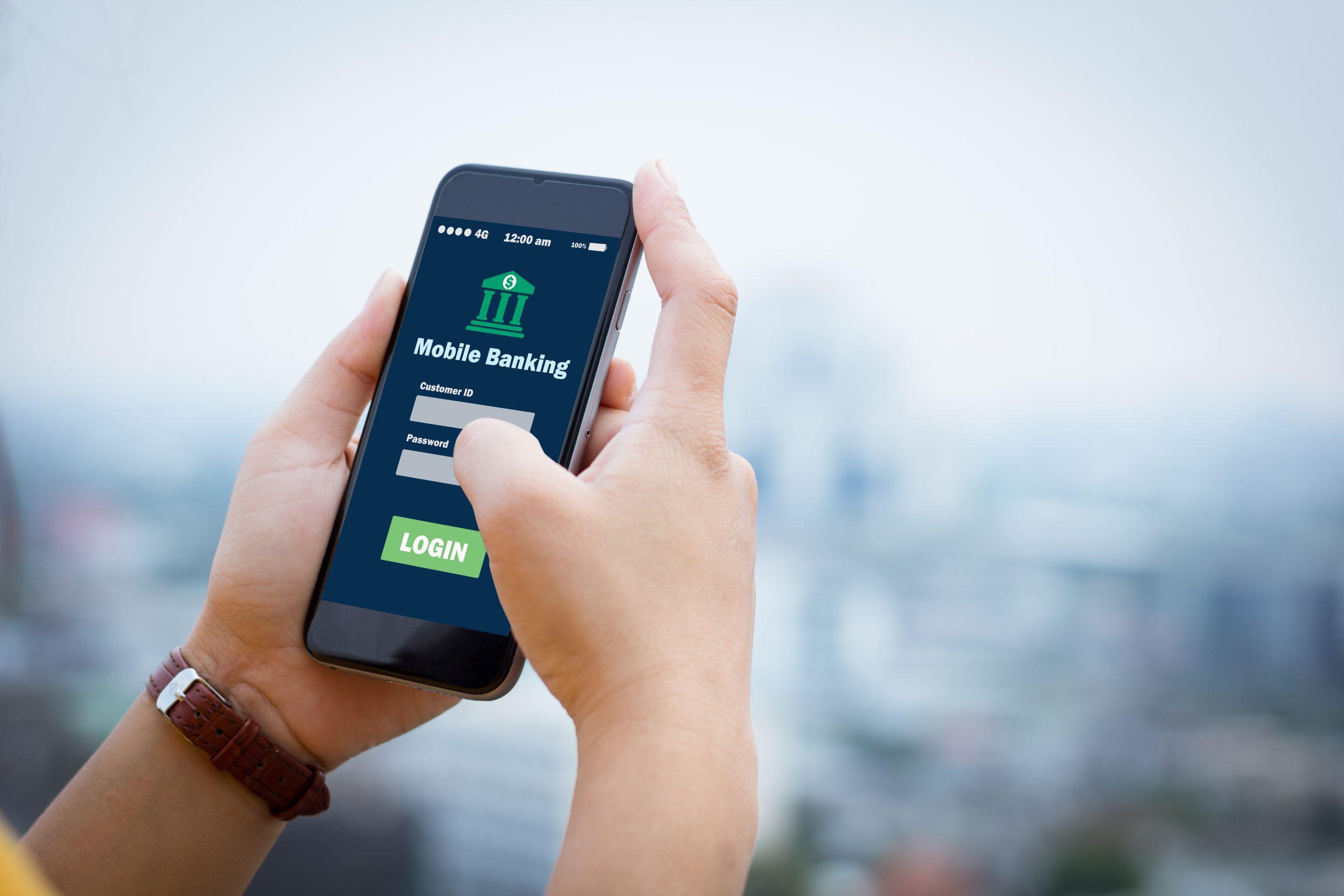 a woman on a phone using mobile banking from a telecom billing and revenue management service company